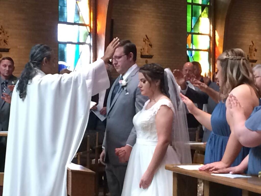 Couple getting married by priest.
