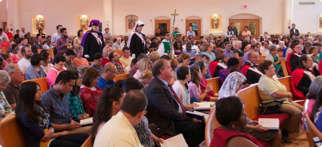 Knights of Columbus processing into Mass with a packed Church