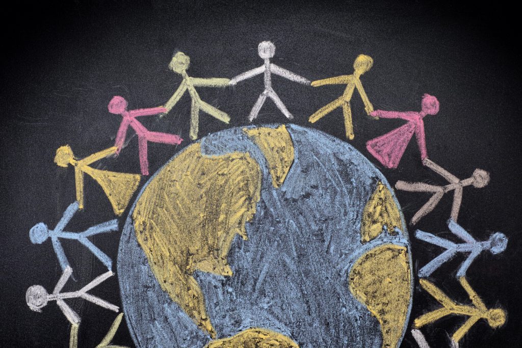 Group of people around the world. Chalk drawing.