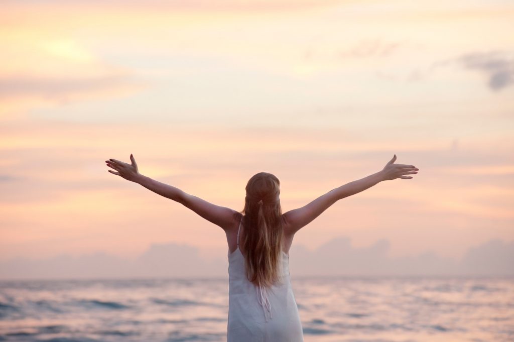 Lady with Arms out at the beach