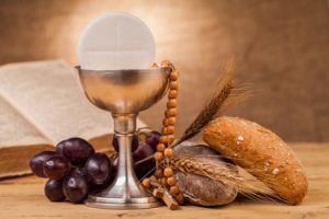 holy communion chalice on wooden table