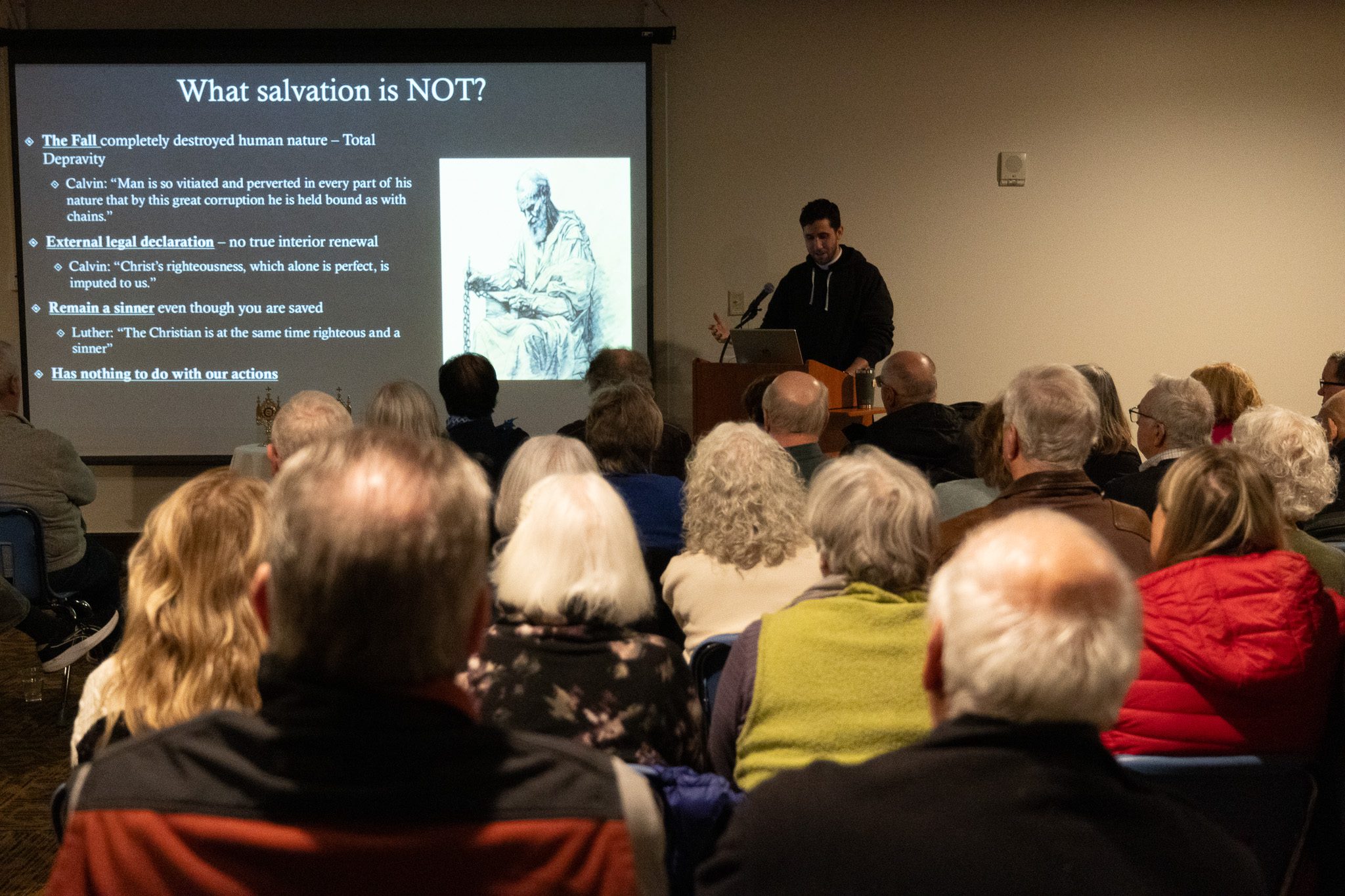 Fr. Girardi presenting on salvation to a full room during Week 1 of the Lent Talk Series