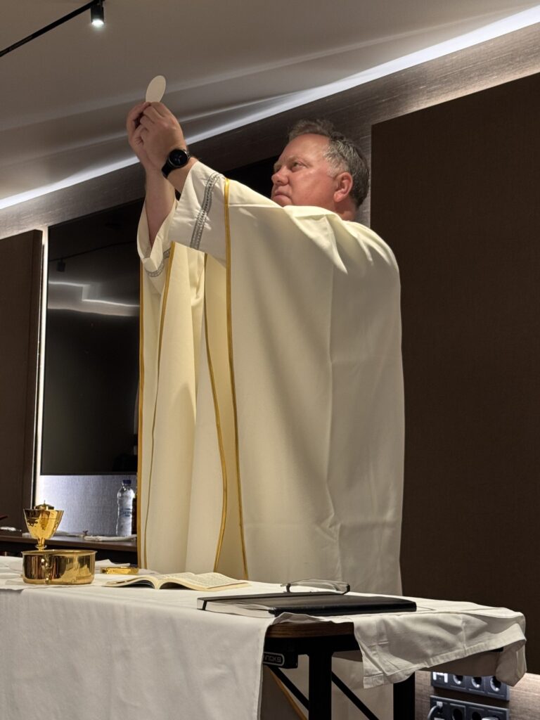 Fr. Wilson elevates the Host at Mass in Athens
