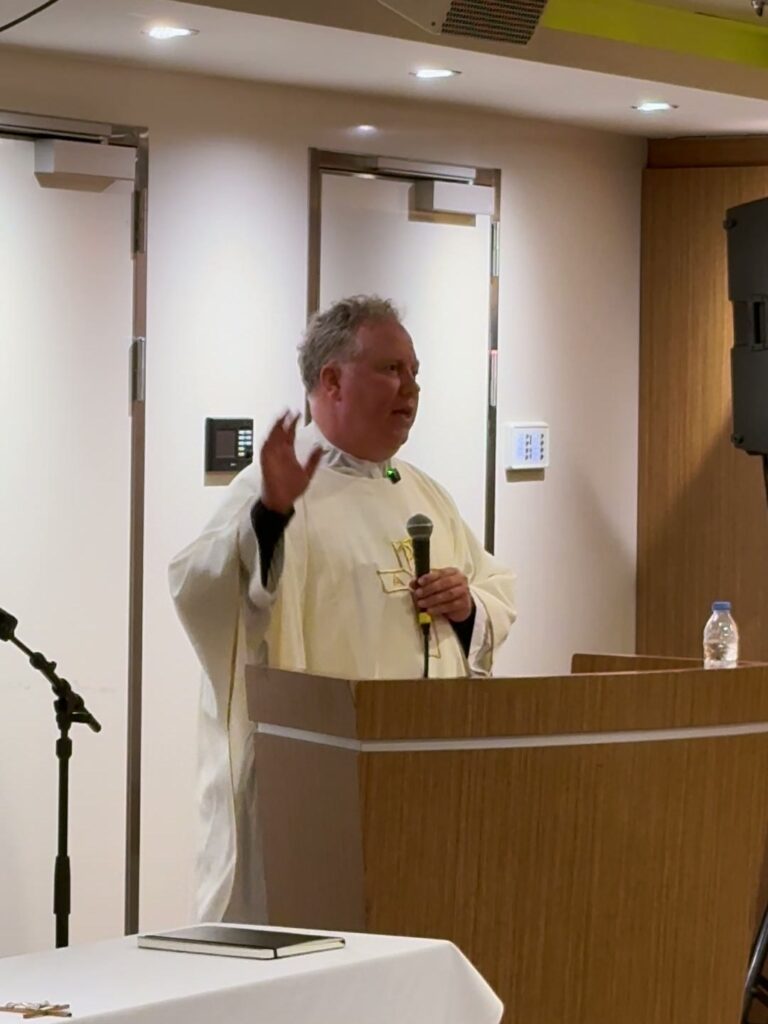 Fr. Jonathan Wilson preaching at Sunday Mass on board the ship