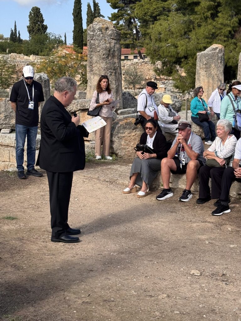 Fr. Wilson reading to the pilgrims among the ruins of Corinth