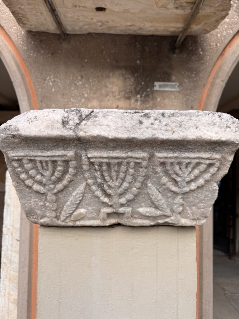 Marble capital carved with three menorahs at the Corinth museum