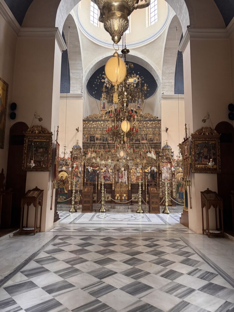 Gilded iconostasis and chandelier inside the monastery church