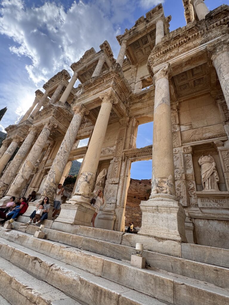 The two-story marble facade of the Library of Celsus seen from below