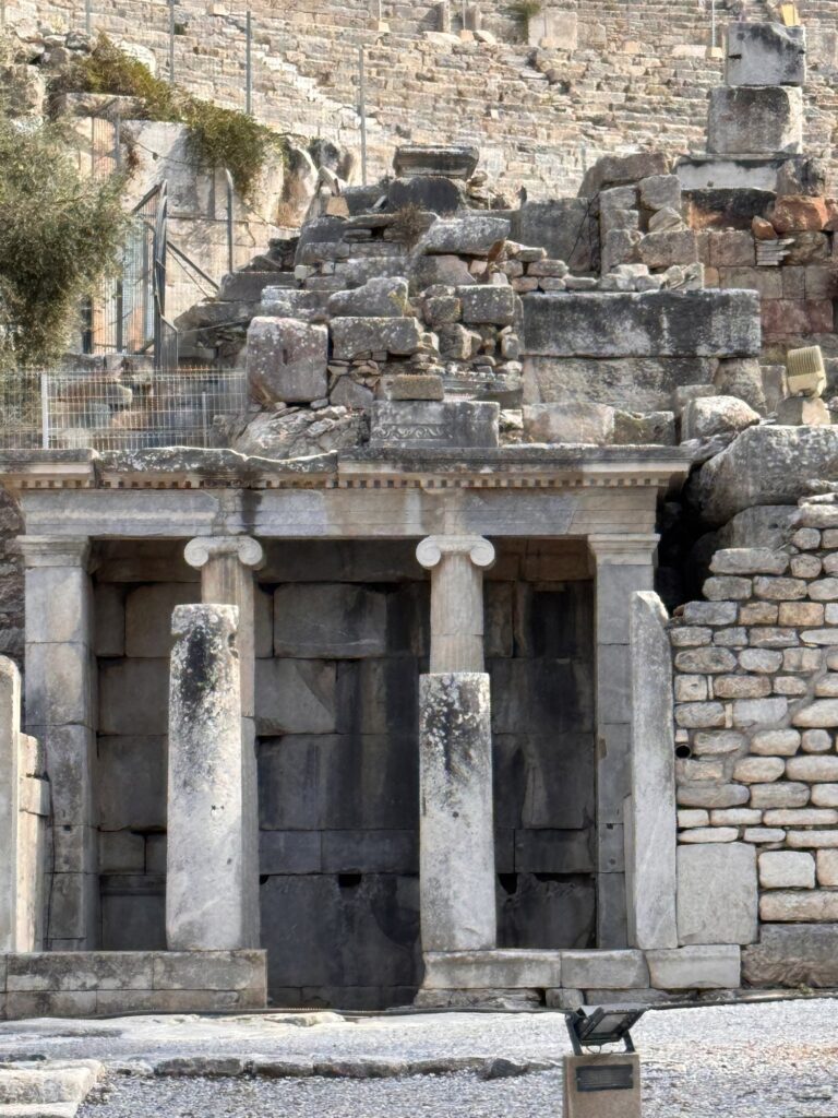 The ruined stage building of the theater in Ephesus with seats rising behind it