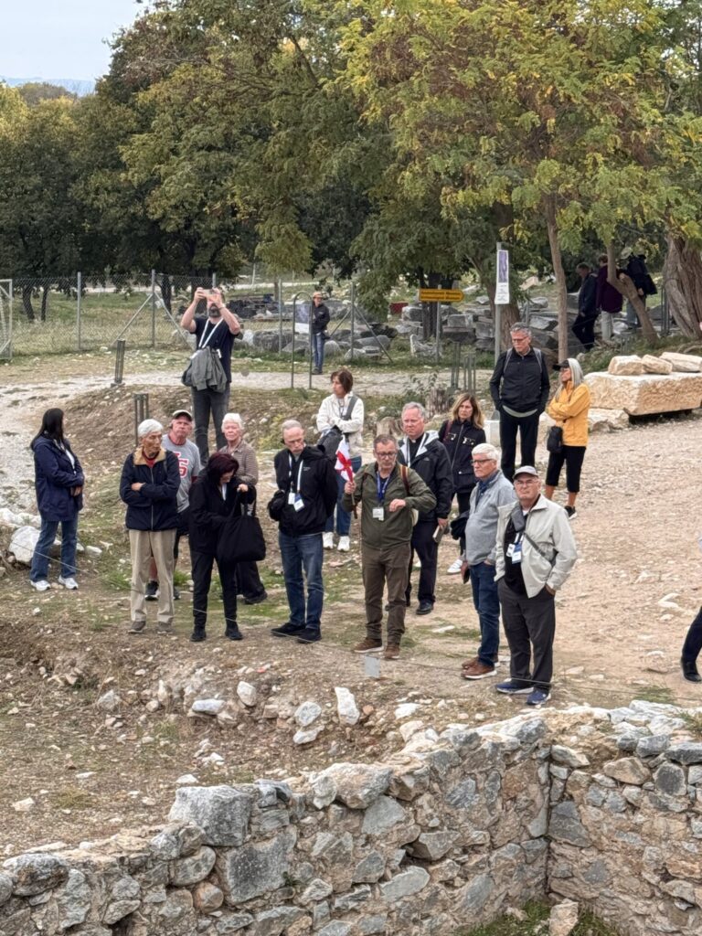 Pilgrims listening to their guide among the ruins of Philippi