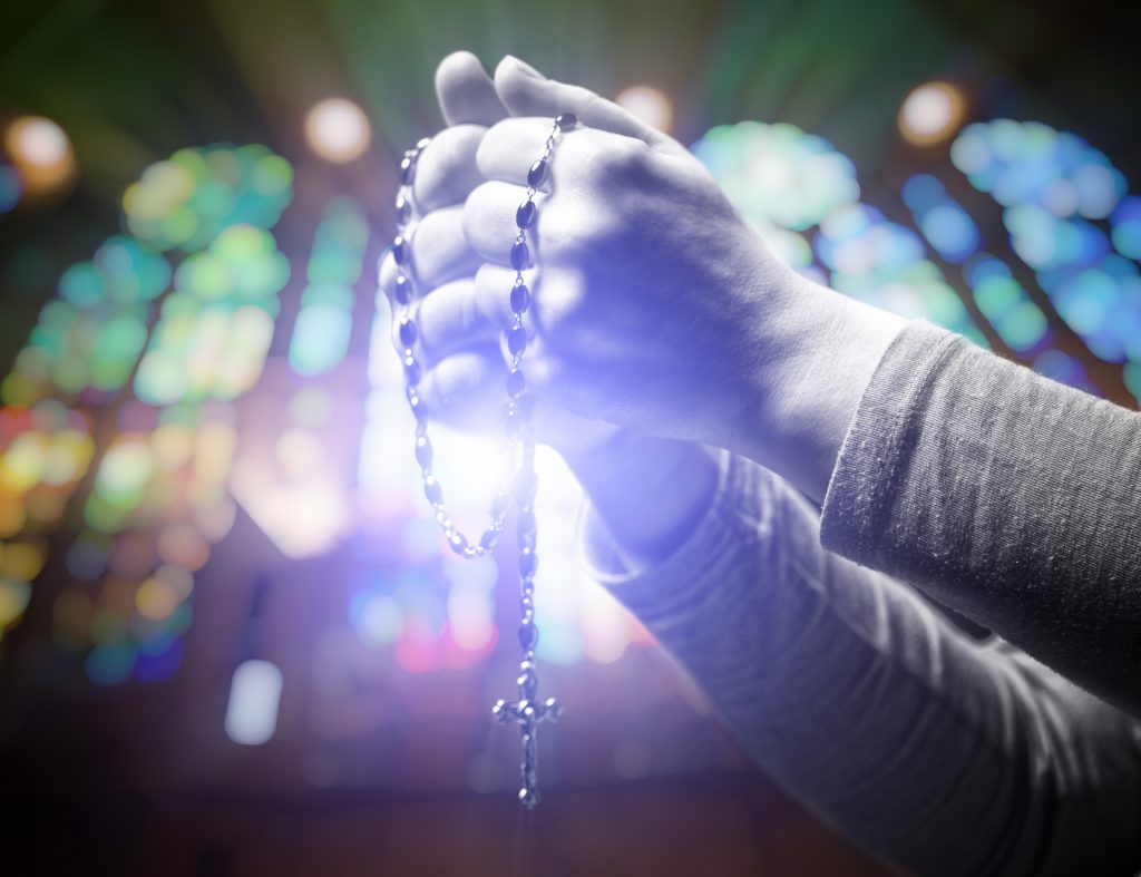 closeup image of hands and rosary