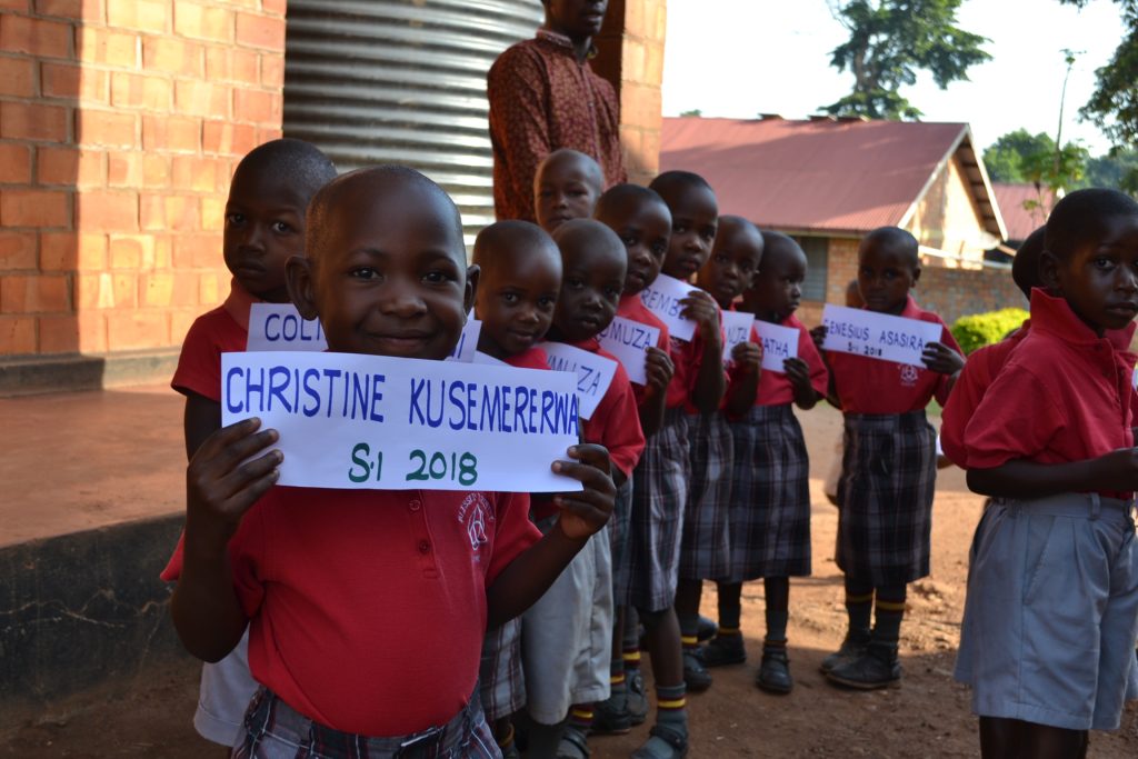 children in line holding signs