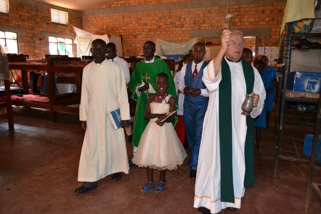 priest blesses dorm room with water