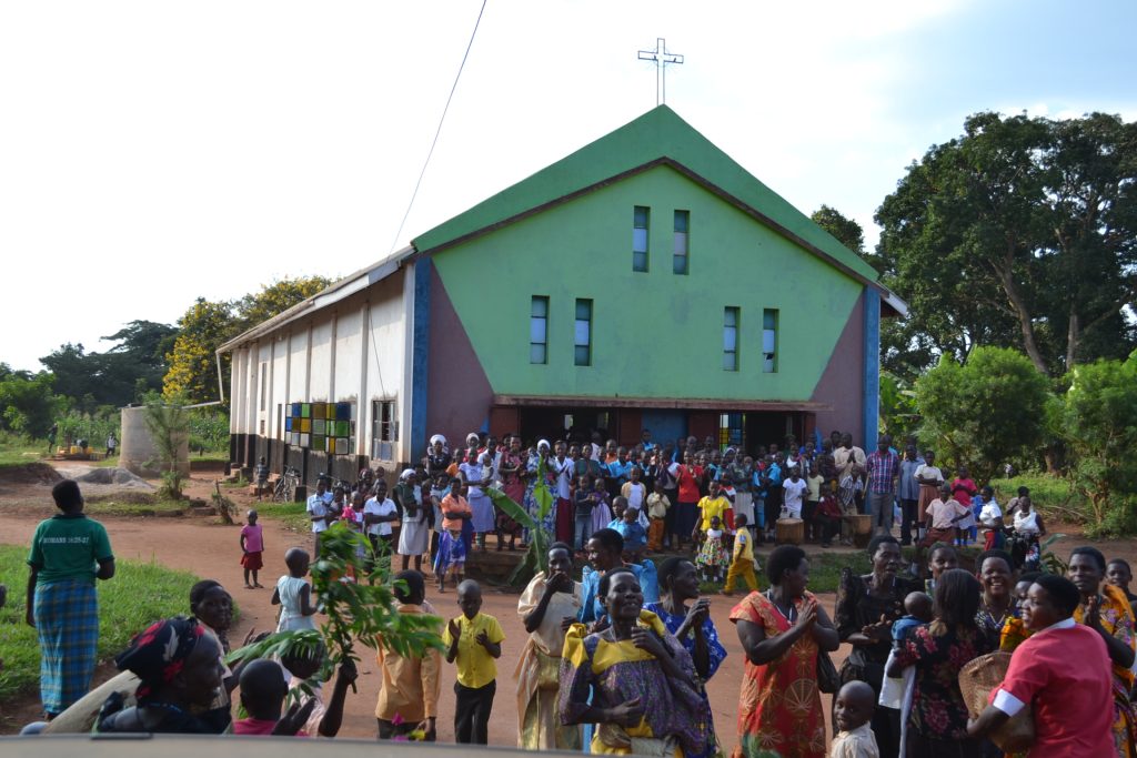 large crowd outside green church