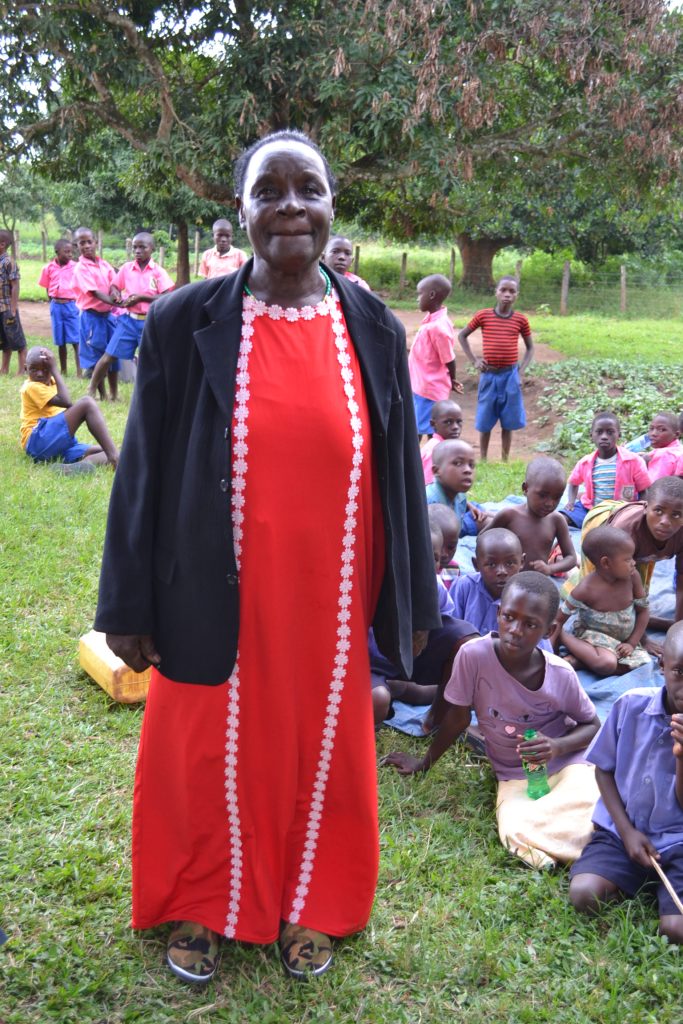 woman standing in red dress with black jacket