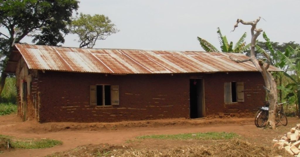 old church with tin roof and mud walls