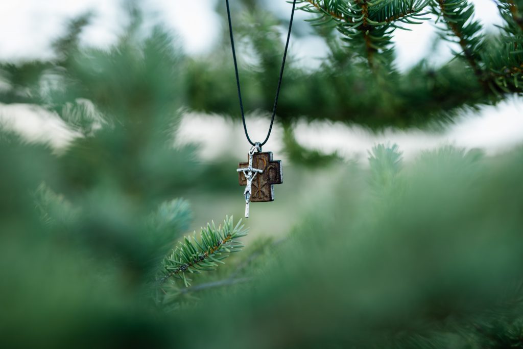 in a forest picture of a crucifix necklace