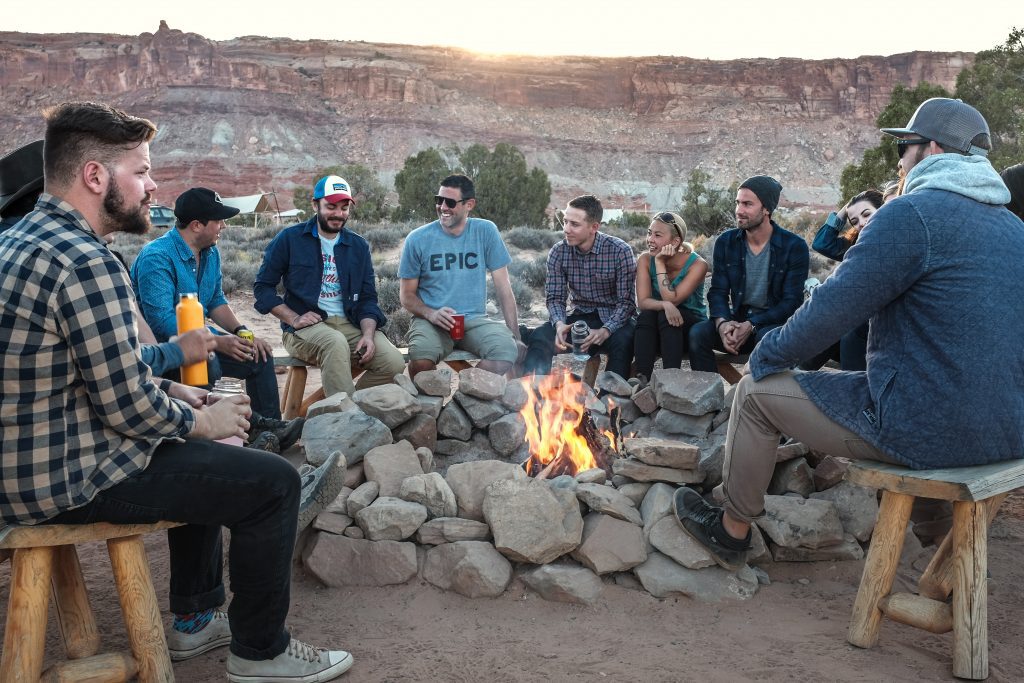 People hanging around a bonfire