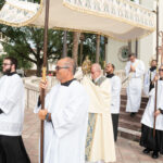 Seminarians bear the canopy as the Corpus Christi procession begins on the steps of St. James Cathedral photo