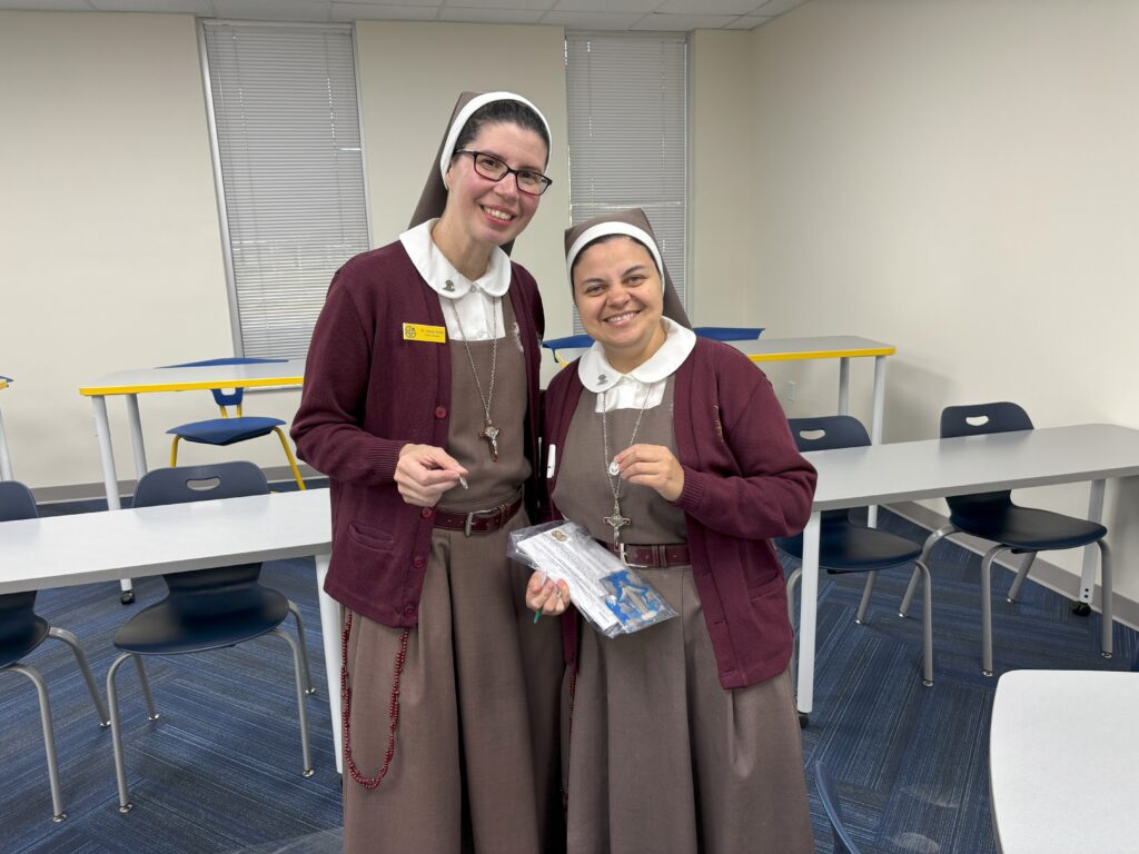 Cristo Rey Ground Breaking Sisters Placing Blessed Medals thru the School