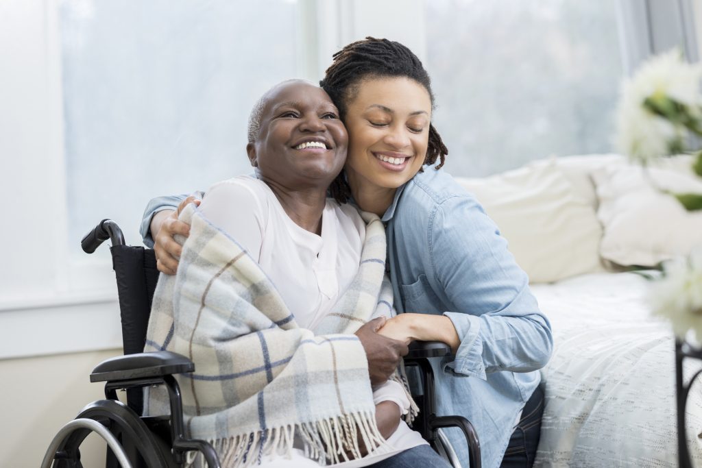 http://Young%20woman%20embraces%20her%20beautiful%20senior%20mother