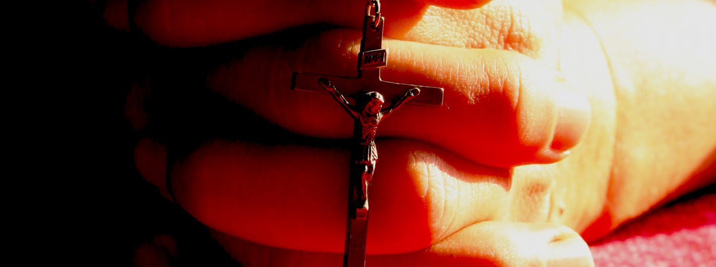 Hands Folded in Prayer with Rosary
