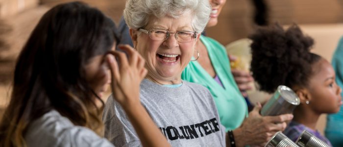 Active senior woman enjoys volunteering at food bank
