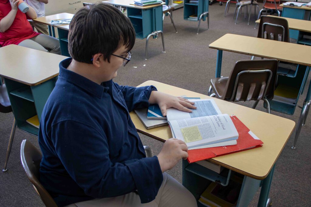 Student reading a book in class
