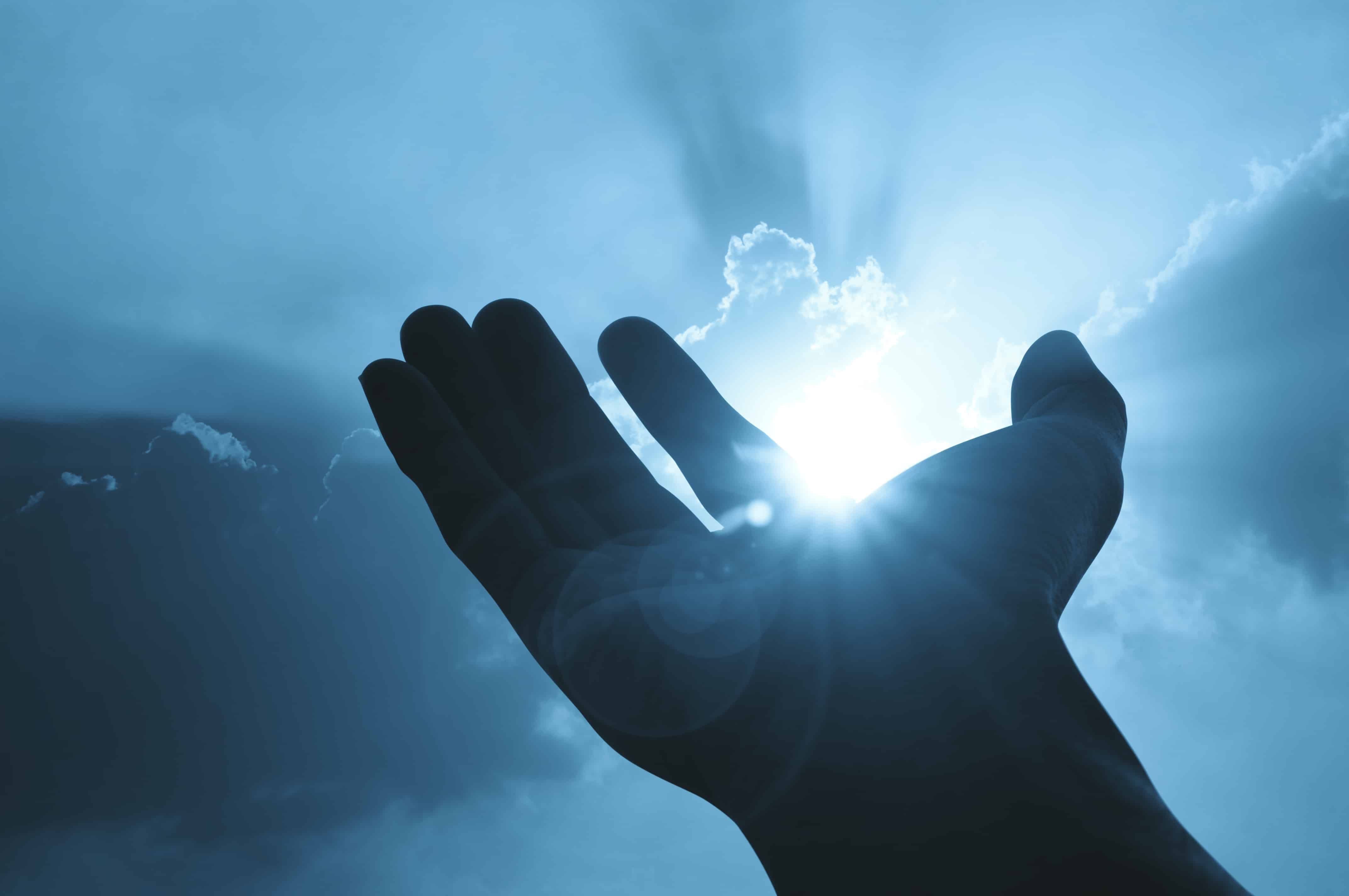 Hand on sunset background success, peace,freedom concept