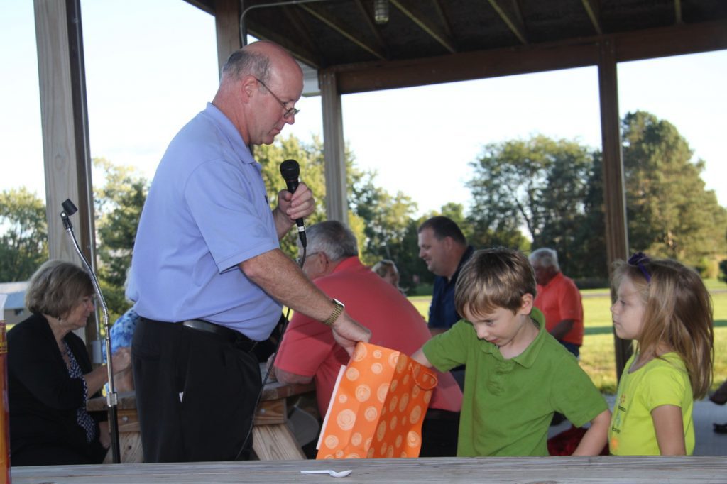 Kid Drawing for the door prize at the parish picnic.