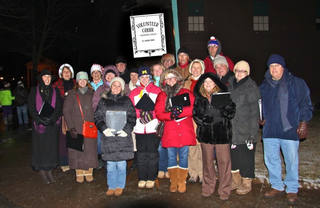 Kelly Rizzo-McLain with choir carolers at Greenfield Village.