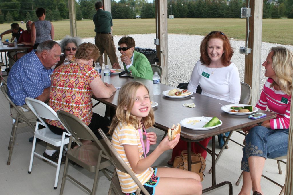 Administrative assistant Catherine Wolfe (2d from right) at parish picnic with former Parish Council president Ann Blakeslee.