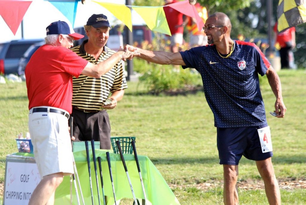 Festival chipping contest congrats, two men shaking hands
