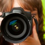 Female photographer taking photos with DSLR digital camera